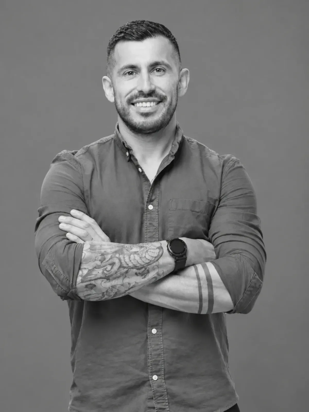Portrait of Rod Acevedo, arms crossed and smiling